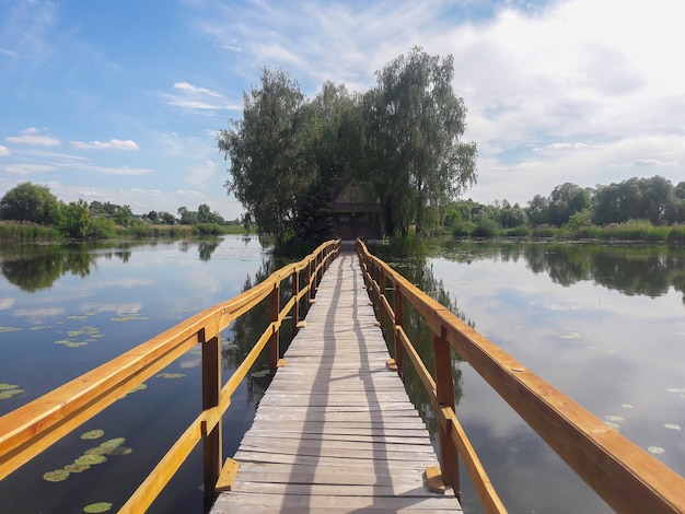 Summer house on an island in the middle of the lake and a bridge to it