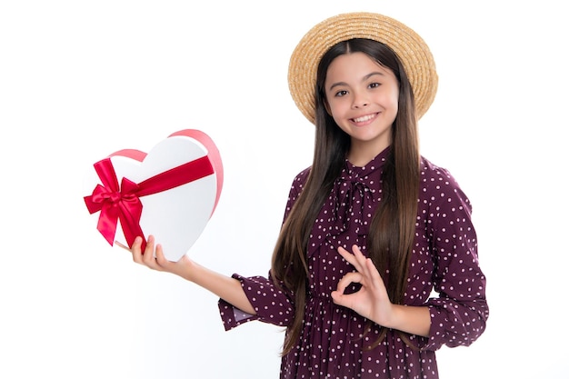 Summer kids sale Portrait of happy smiling teenage child girl Surprised teenage child holding gift box on white isolated background Gift for kids birthday Christmas or New Year present box