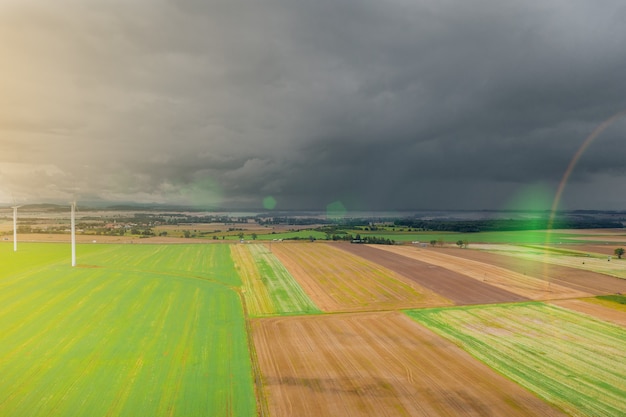 Summer landscape with a thundercloud over fields and forests, view from above