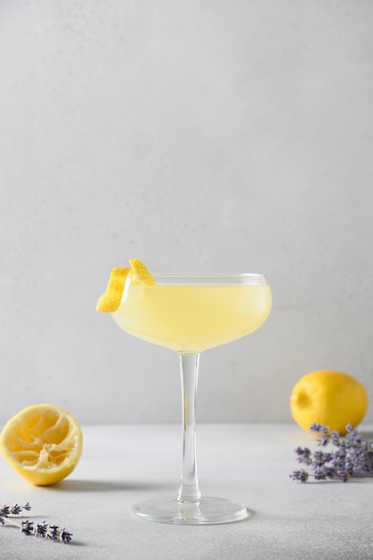 Summer lavender lemonade with citrus in glass on white background