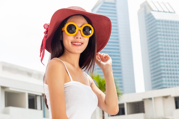 Summer lifestyle Asian portrait of pretty girl standing in city.