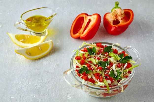 Summer light salad of fresh white cabbage paprika and parsley seasoned with oil and lemon in a glass