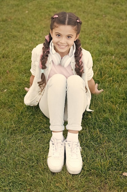 summer means happy times and good sunshine small child enjoying summer vacation little girl relaxing on green grass on summer day summer time summertime