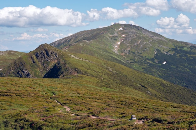 Summer mountain view with observatory building on mountain peak (with observatory ruins on Chornogora Ridge, Ukraine)