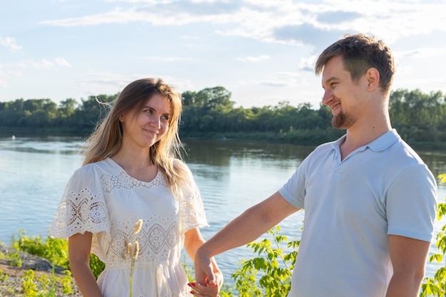 Summer nature and relationship concept - Happy smiling couple in love.