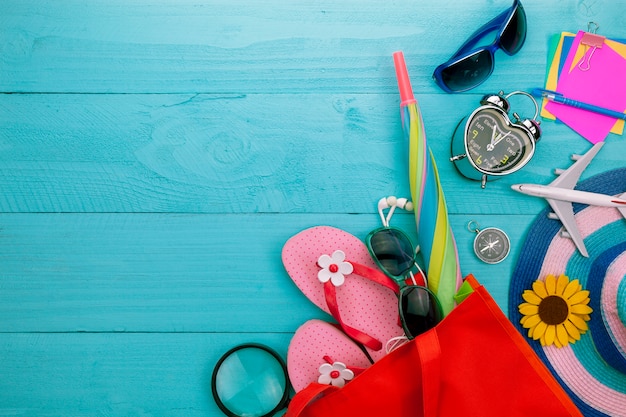 Summer objects of beautiful summer accessory on blue wooden background with copyspace