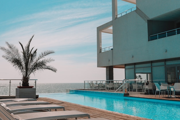 Summer outdoor swimming pool and sun loungers. In the hotel to rest.