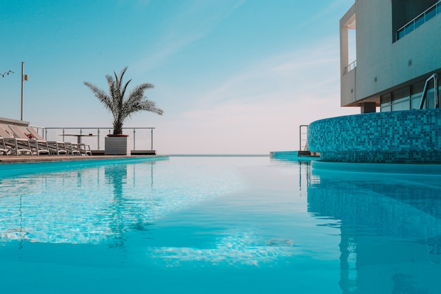 Summer outdoor swimming pool and sun loungers. In the hotel to rest.