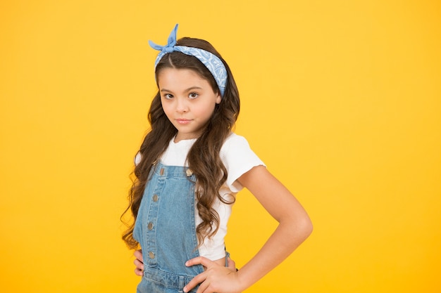 Summer outfit concept. Girl long curly hair. Fashion trend. Little fashionista. Happy childhood. Modern teen clothing. Accessory shop. Positive vibes. Cute small kid fashion girl. Fashion accessories.