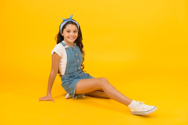 Photo summer outfit concept girl long curly hair sit relaxing fashion trend little fashionista carefree happy childhood modern clothing for teen cute small kid fashion girl fashion accessories