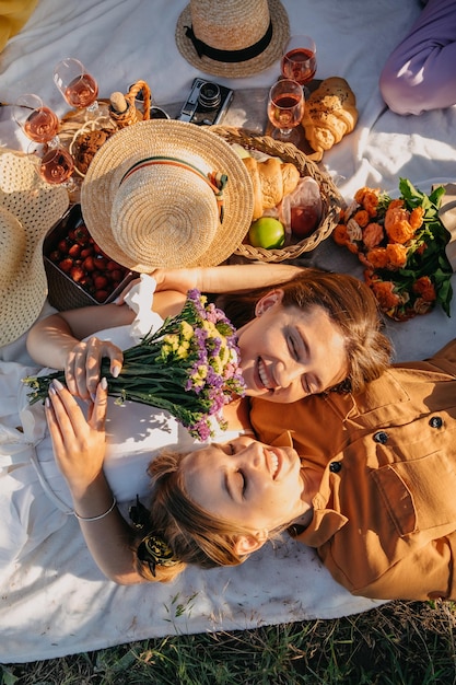 Summer party outdoor gathering with friends two young women friends at the picnic having fun on