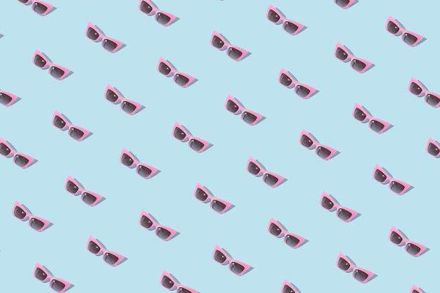 Summer pattern pink sunglasses on blue background Minimal concept