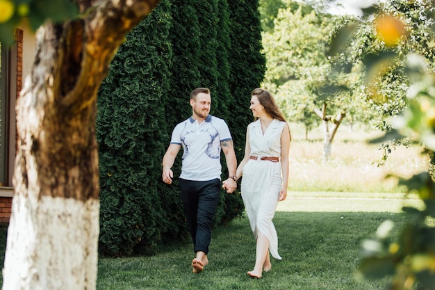 Summer photo of beautiful young couple in the garden