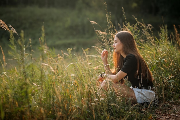 Photo summer photo of a girl on the background of a grass meadow 3656