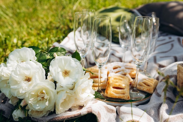 Summer picnic on sunny day with bread fruit bouquet hydrangea flowers glasses wine