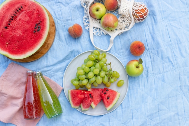 Summer picnic with healthy fruits on a blanket