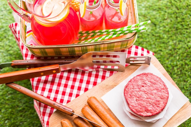 Summer picnic with small charcoal grill in the park.