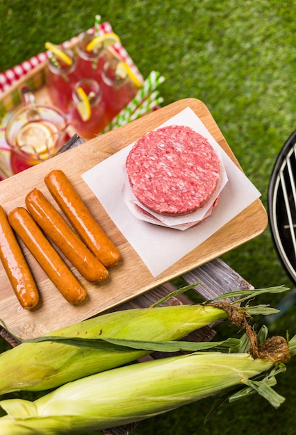 Summer picnic with small charcoal grill in the park.