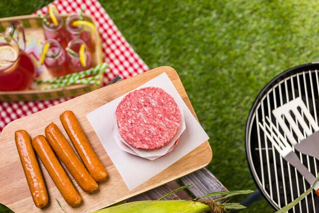 Summer picnic with small charcoal grill in the park.