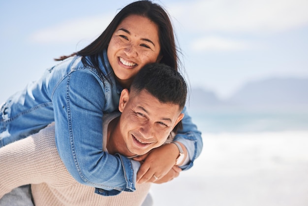 Summer piggyback and portrait of a couple at the beach for a date love or vacation together Mockup smile and a man and woman with a hug at the sea for a holiday travel or bonding in marriage