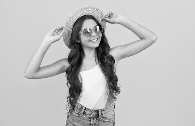 Summer portrait summer party look happy funny kid in eyeglasses and straw hat