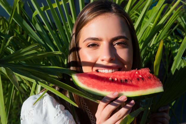 Summer portrait woman is holding a slice of watermelon tropical vacation travel concept positive cha