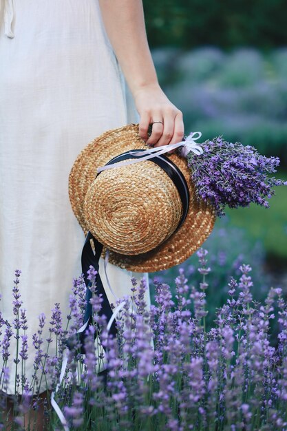 Summer in Provence France Charming young woman in Blooming Lavender fields Young girl in hat