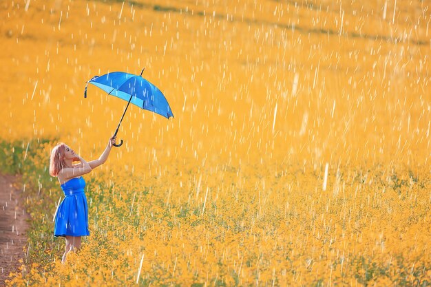 Summer rain field girl flowers, beautiful young lady in spring field with flowers happiness freedom