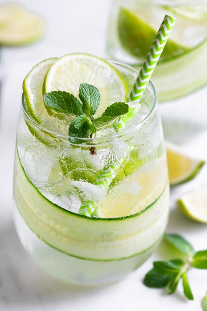 Summer refreshing cocktail with lime and cucumber selective focus closeup