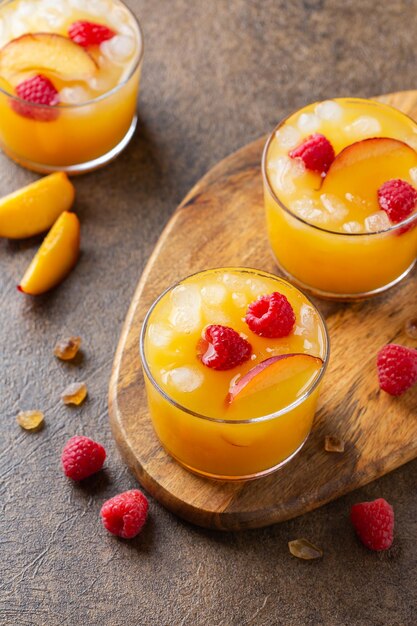 Summer refreshing drink beverage cocktail with peach and raspberry