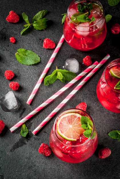 Summer refreshing non-alcoholic cocktails. Fruit drinks. Raspberry mojito lemonade with fresh organic mint and lime. 