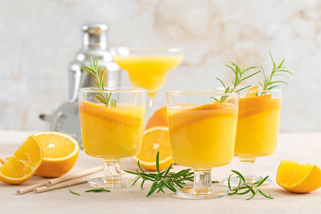 Summer refreshing orange cocktail with rosemary and fresh fruits