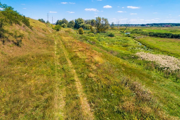 Summer rural landscape Aerial view View of the countryside Country road on the hill