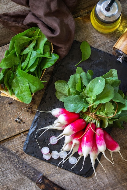 Summer salad ingredients organic vegetables and olive oil Raw fresh juicy radish Top view