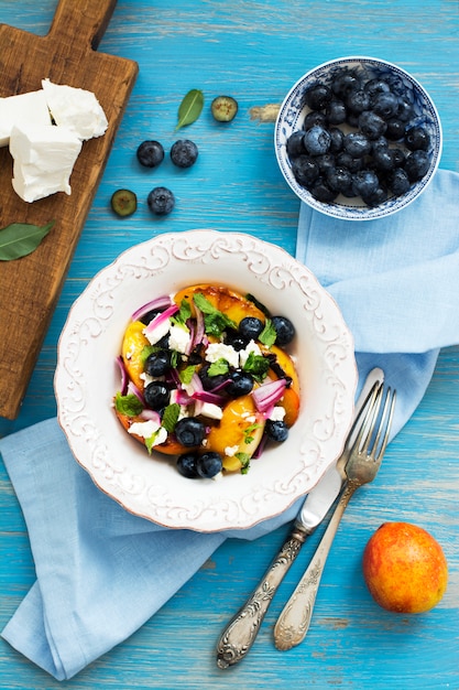 Summer salad with grilled peaches, blueberry and feta cheese