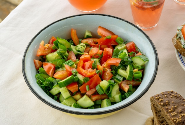 Summer salad with tomatoes, cucumbers, and greens