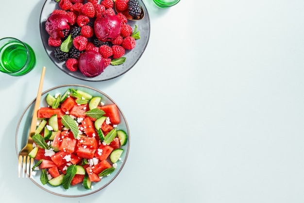 Summer salads with watermelon and cucumbers, berries and ice cream