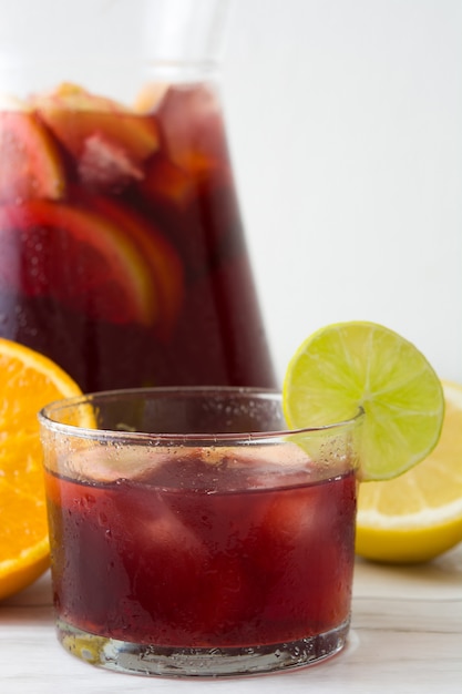 Summer sangria in glass on white wooden table