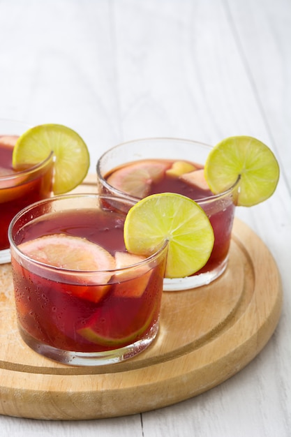 Summer sangria in glass on white wooden table