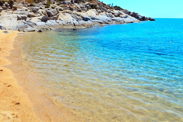 Summer sea scenery with aquamarine transparent water and sandy Agridia Beach (Sithonia, Halkidiki, Greece).