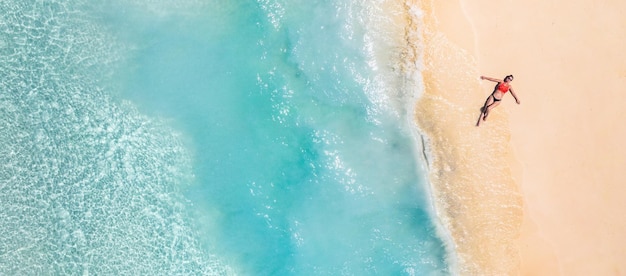 Summer seascape beautiful waves, blue sea water in sunny day. top view from drone. sea aerial view