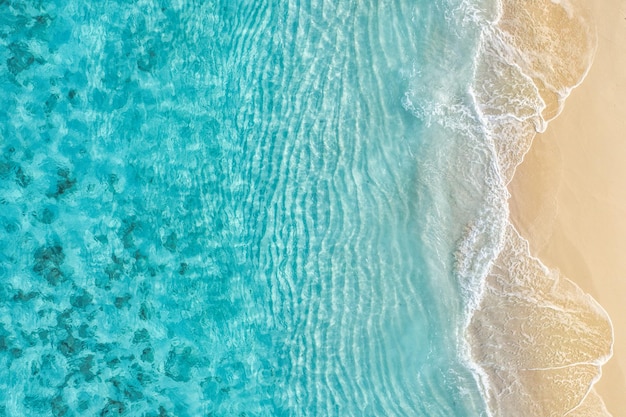 Summer seascape beautiful waves, blue sea water in sunny day. Top view from drone. Sea aerial view,