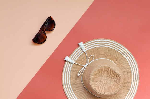 Summer straw hat on red and pink