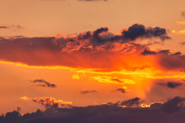 Summer sunset Storm clouds on the background of the orange sky