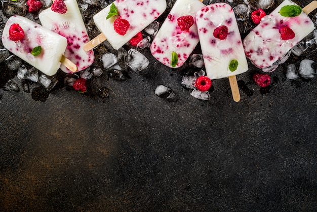 Summer sweet desserts, homemade organic ice cream popsicles from raspberry and yogurt