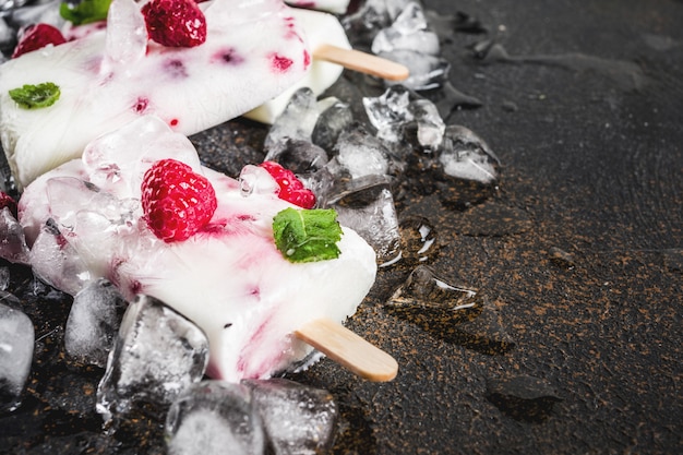 Summer sweet desserts, homemade organic ice cream popsicles from raspberry and yogurt