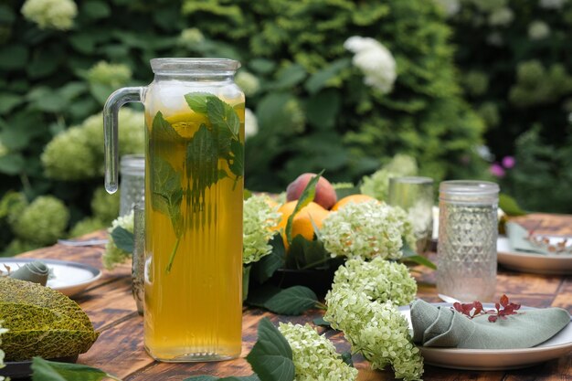 Summer table set Lemonade decanter on dining table outdoors