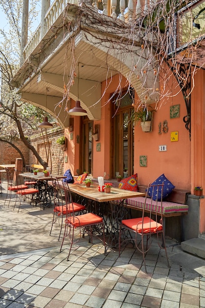 Summer terrace and restaurant table on the street in a cozy old district of Tbilisi. Tbilisi, Georgia - 03.17.2021