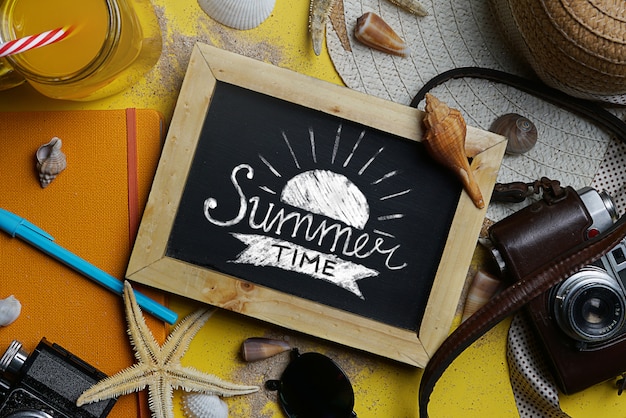 Photo summer time typography on blackboard between summer beach accessories