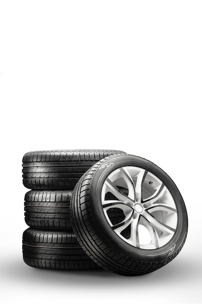 Summer tires and wheels stack on a white surface